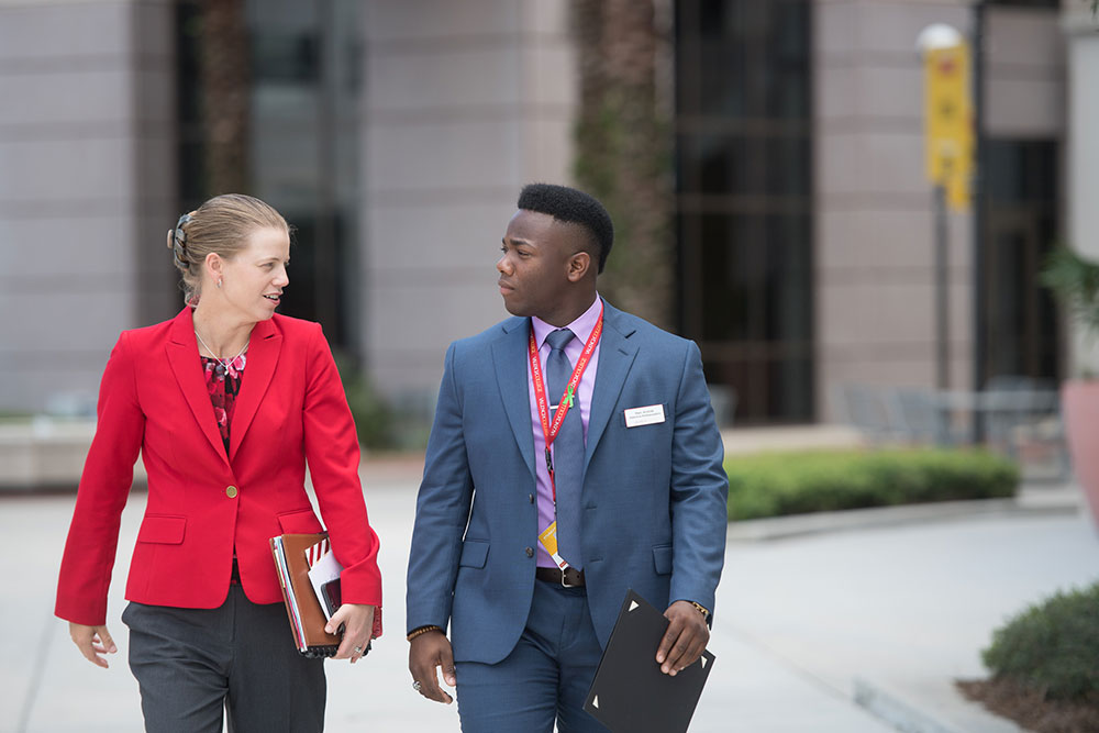 Marc Aristide walking with Kathleen Plinske