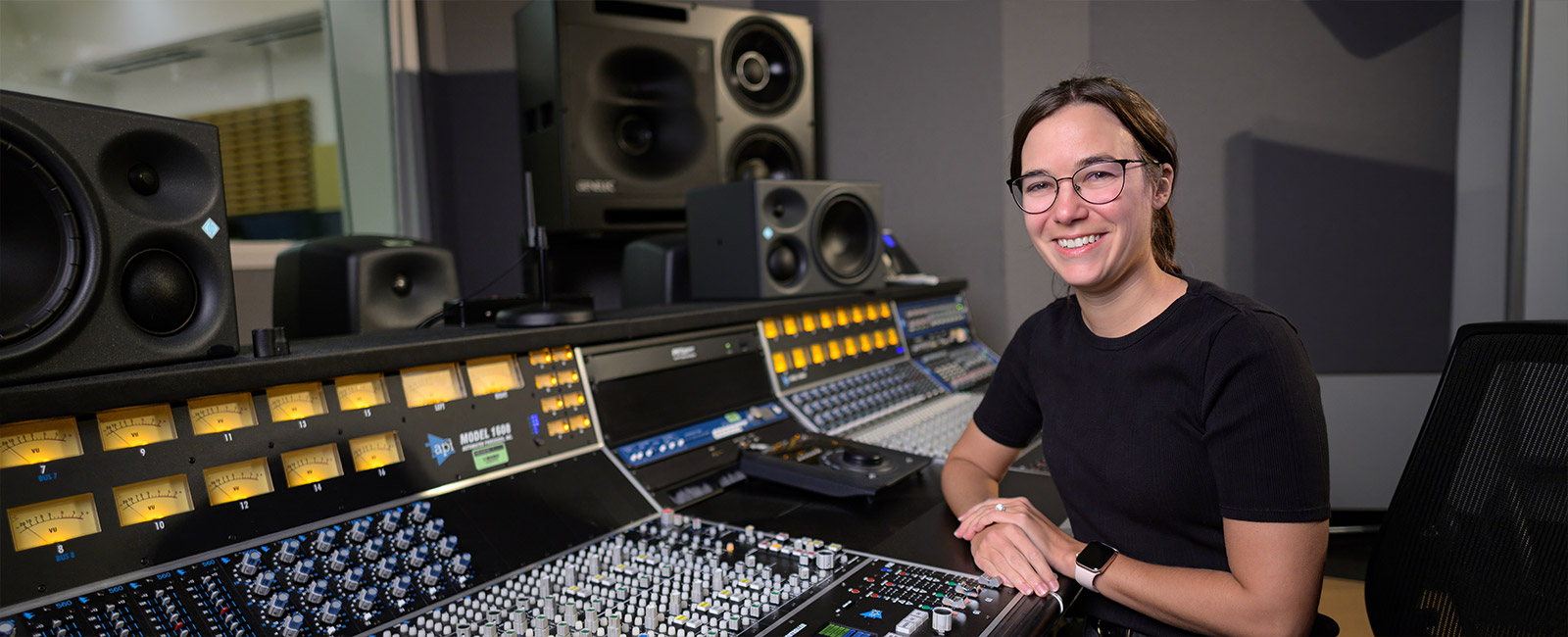 Melodie Cros sitting at the sound board