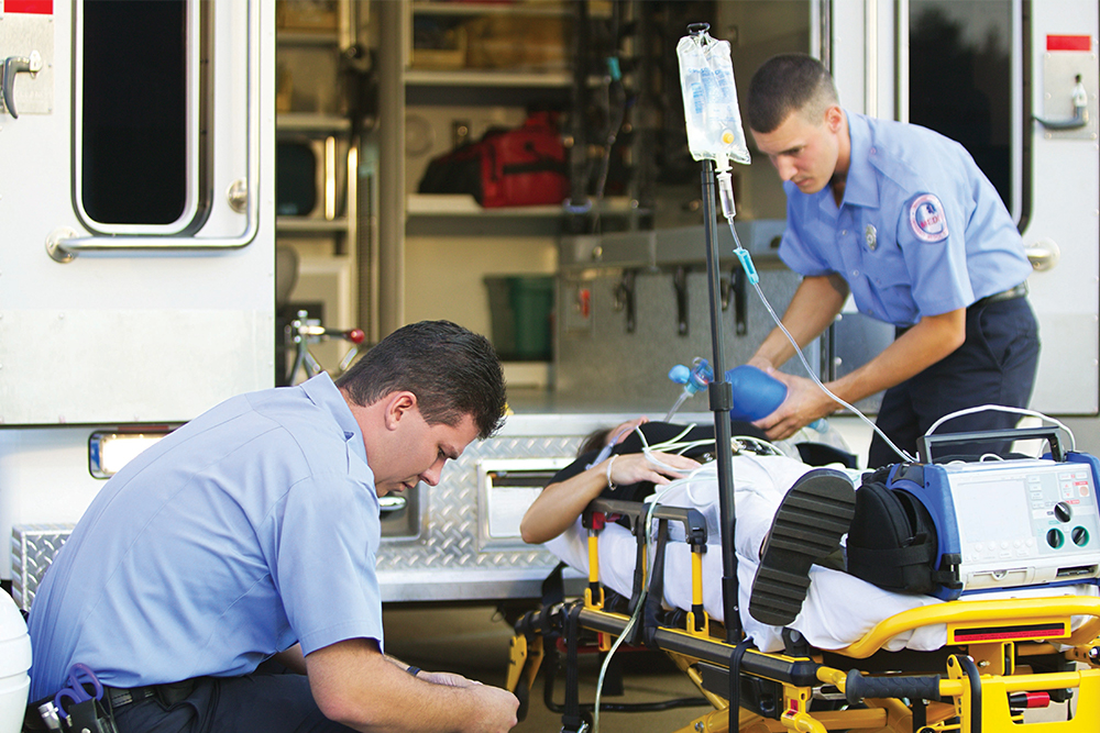 Emergency Medical Services technicians assisting patient
