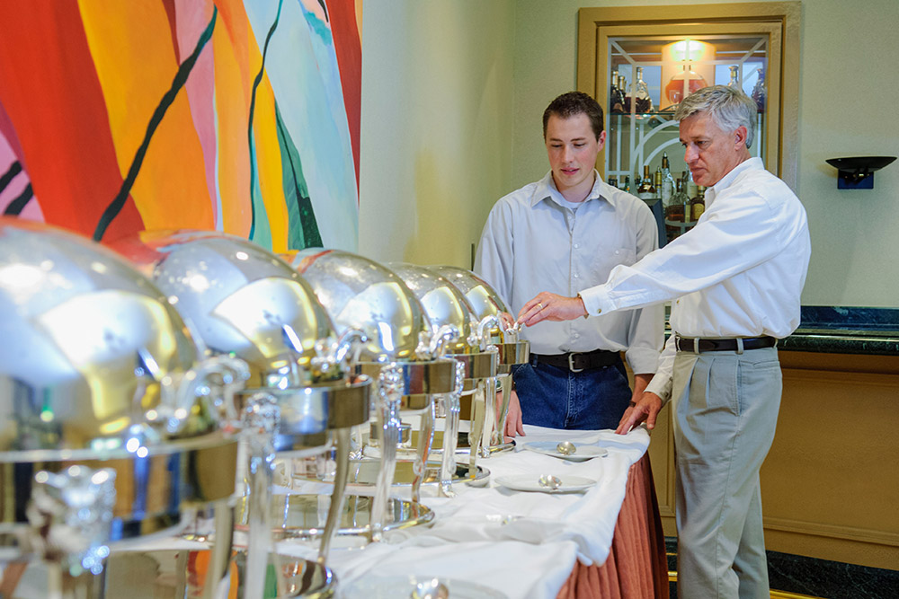 Professor and student preparing banquet