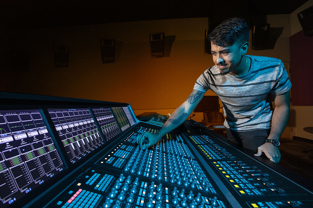 Sound and Music Technology male student at sound board
