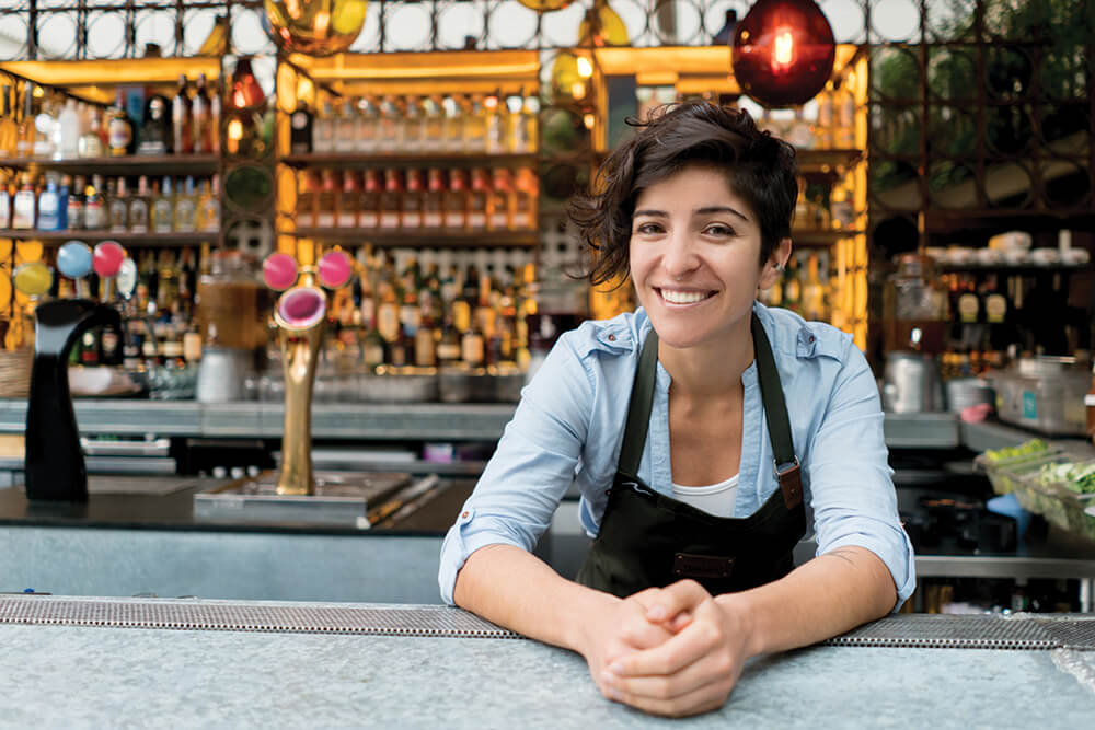 Careers in culinary arts - Female bartender smiling