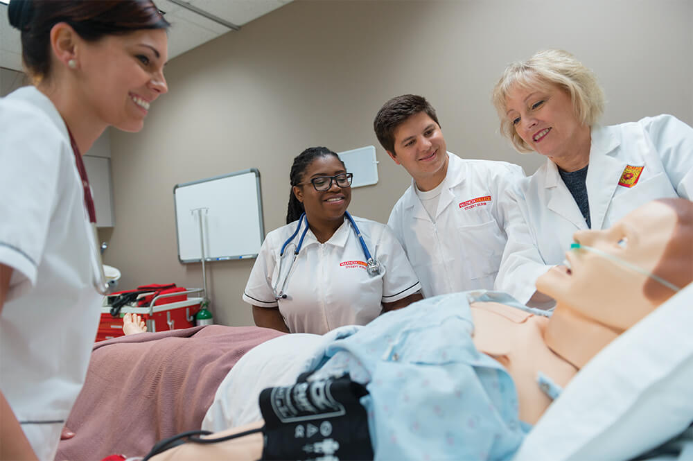 Nursing lab, nurse students training with female instructor at bedside