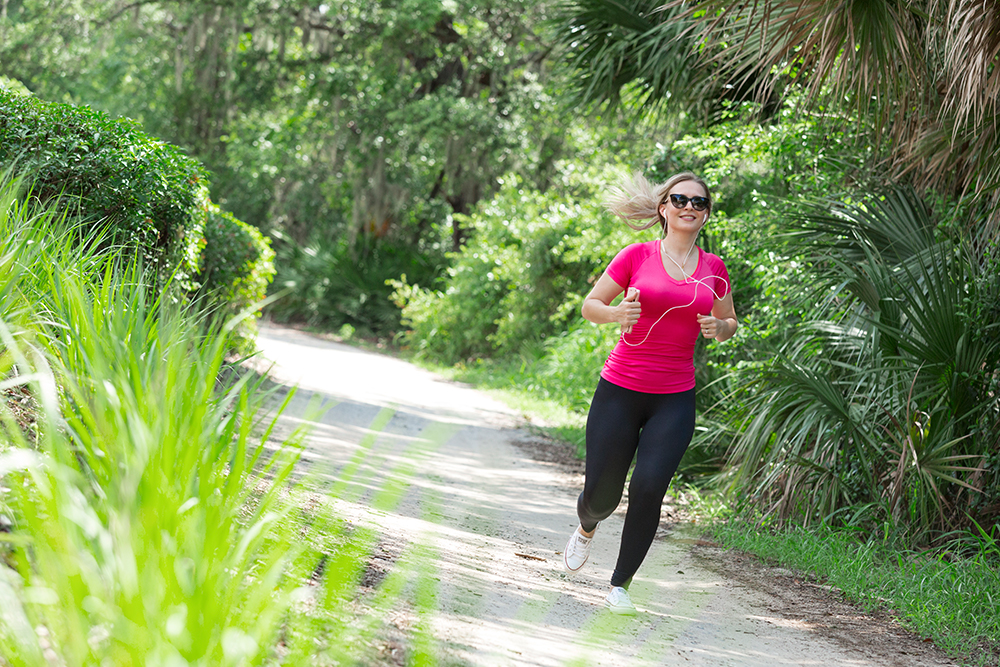 Amenities female jogging on nature trail