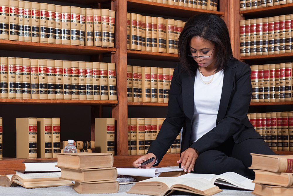 Paralegal Studies female student studying with books on table